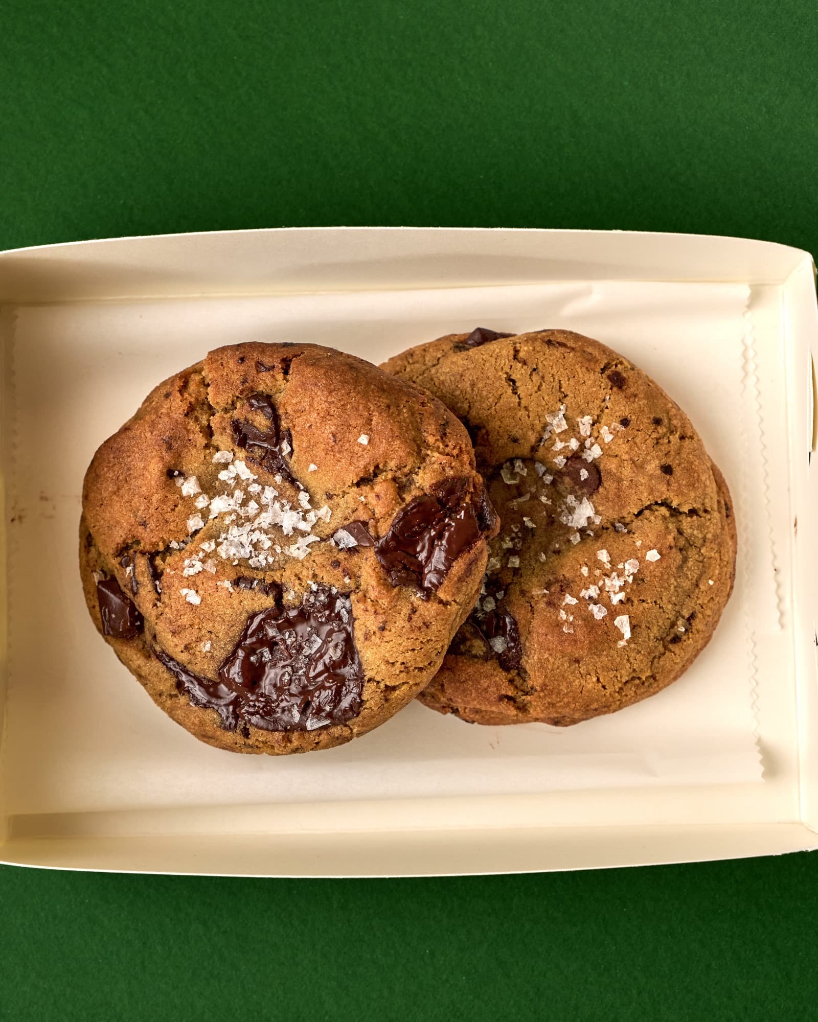 Partners in Crime: two Bad Boy cookies in an open tray, from above.